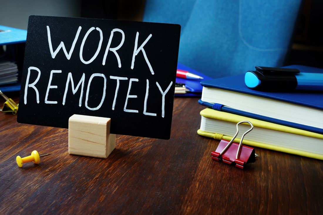 Work remotely sign on the desk about remote job.